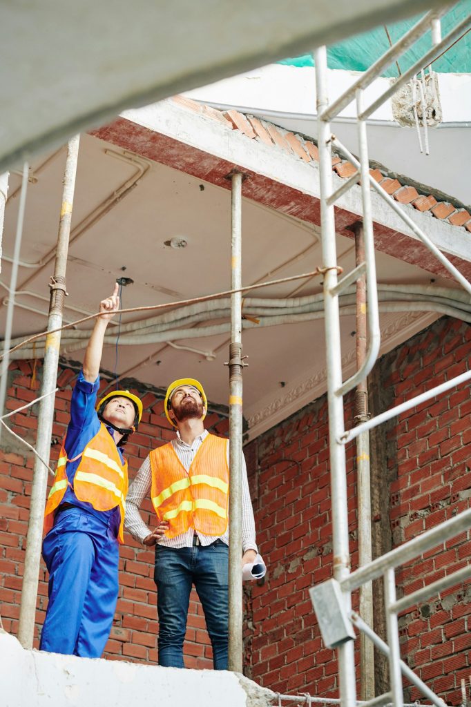 Builders discussing roof renovation